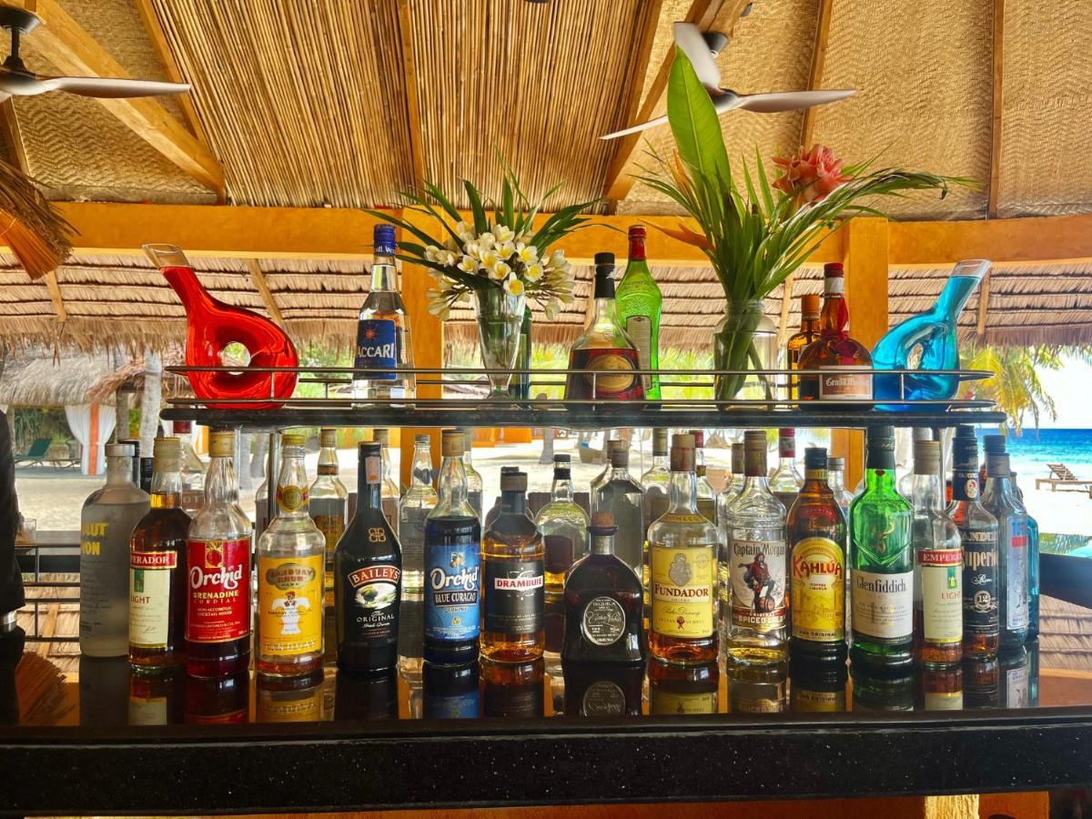 Coco Grove Beach Resort, Siquijor Island Esterno foto Rum bottles at a bar in the Caribbean